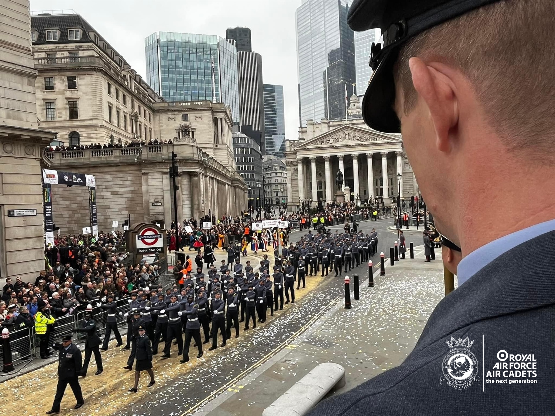 An officer overlooks a large contingent of air cadets marching through the centre of London 